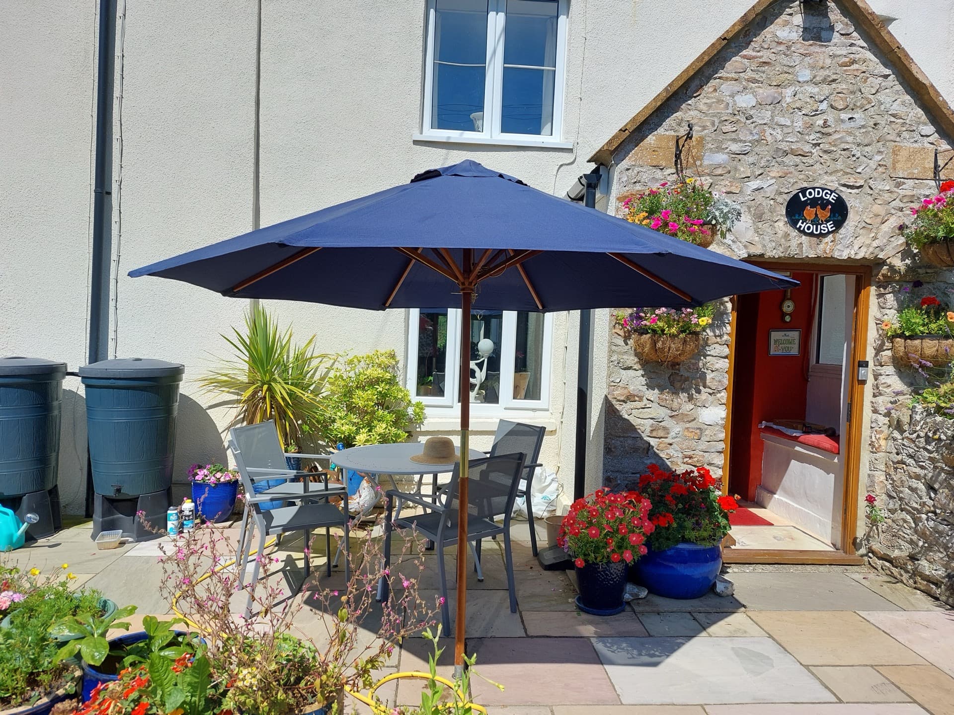 Lodge House entrance with stone walls and beautiful gardens